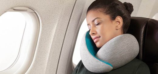 Woman sleeping comfortably on plane using twisted Dot&Dot travel pillow around neck