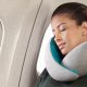 Woman sleeping comfortably on plane using twisted Dot&Dot travel pillow around neck