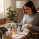 Expecting mother opening thoughtful pregnancy gift including comfort items and practical maternity essentials for her journey