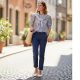 Woman wearing navy chinos with white pointed-toe ballet flats and striped shirt for casual weekend outfit styling